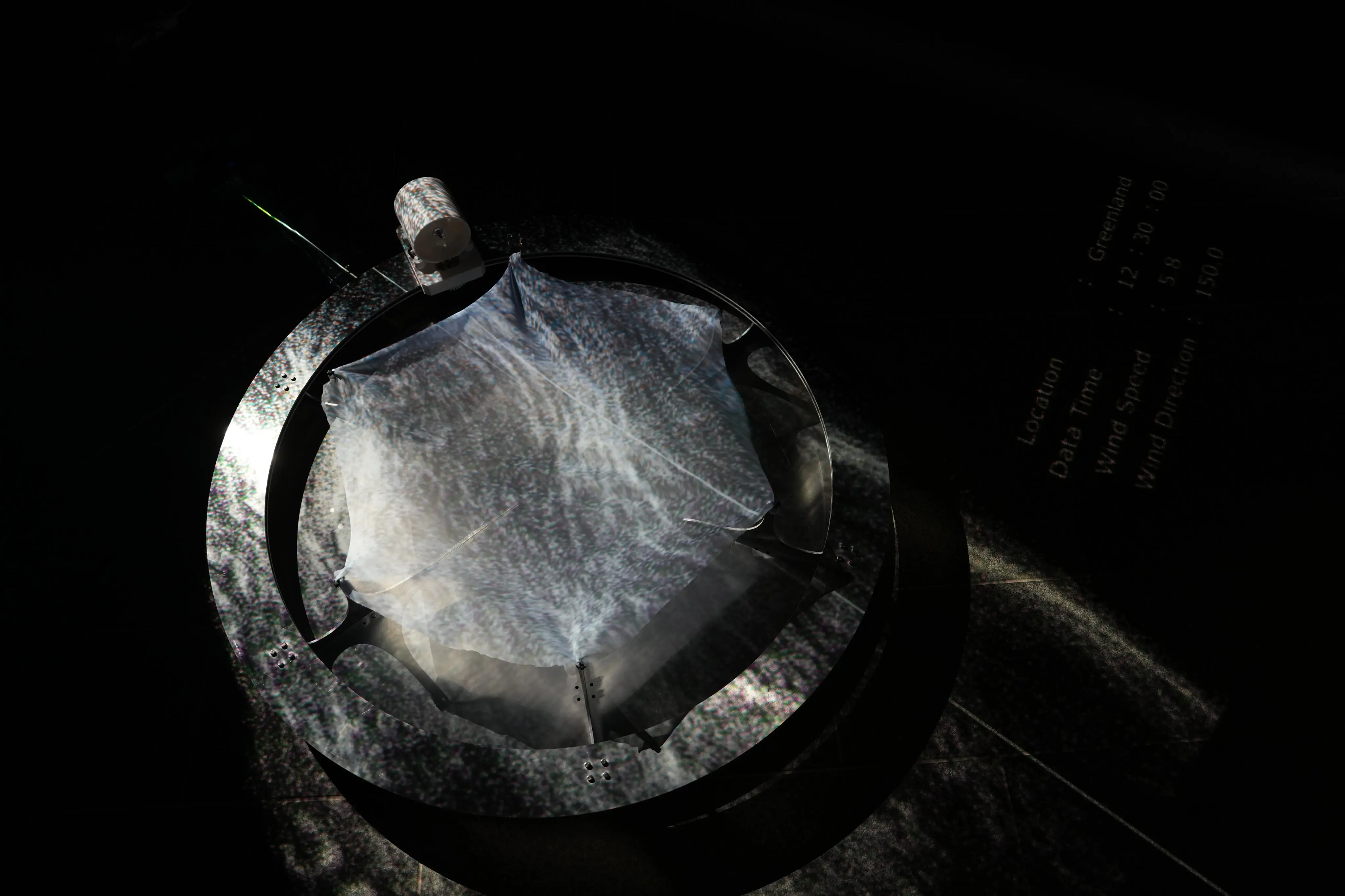 The installation seen in the darkened space